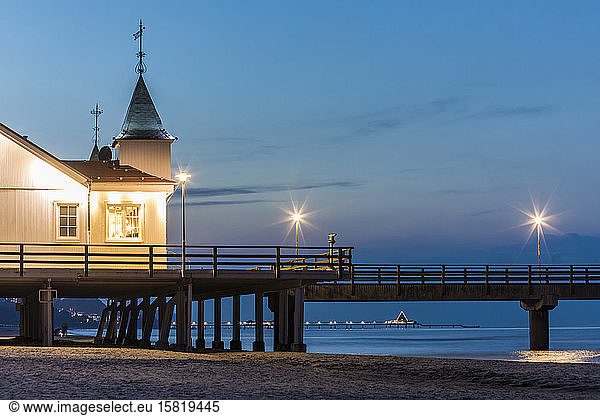 Germany  Mecklenburg-Western Pomerania  Heringsdorf  Illuminated pier and seaside resort at dusk