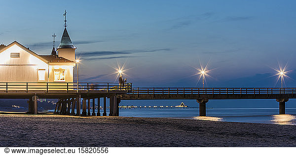 Germany  Mecklenburg-Western Pomerania  Heringsdorf  Illuminated pier and seaside resort at dusk