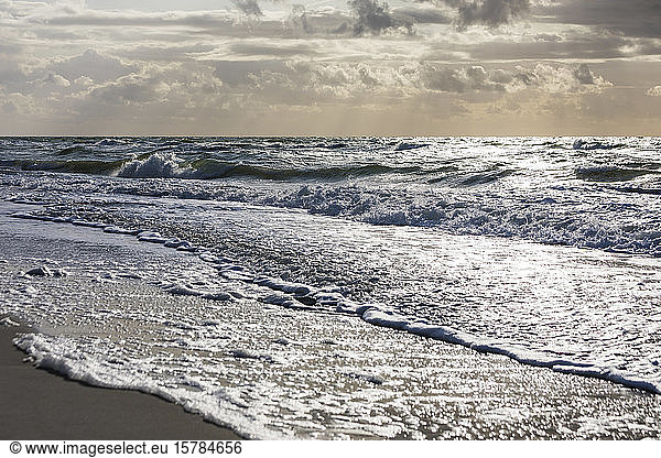 Germany  Mecklenburg-Western Pomerania  Prerow  Waves brushing sandy coastal beach of Baltic Sea at dusk