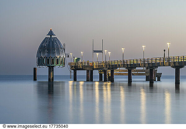 Germany  Mecklenburg-Western Pomerania  Zingst  Long exposure of Zingst Pier at dusk with Tauchgondel in background
