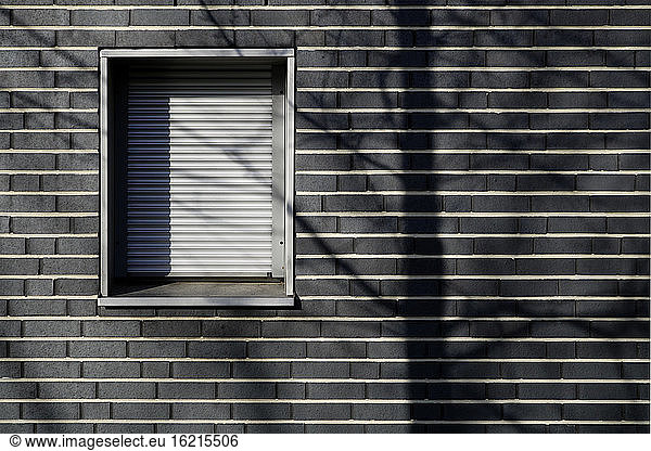 Germany  Munich  Bricked wall house with shuttered window