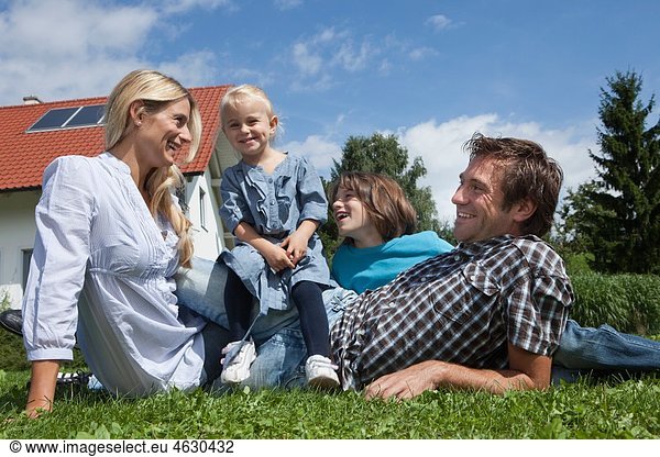 Germany  Munich  Family in garden  smiling