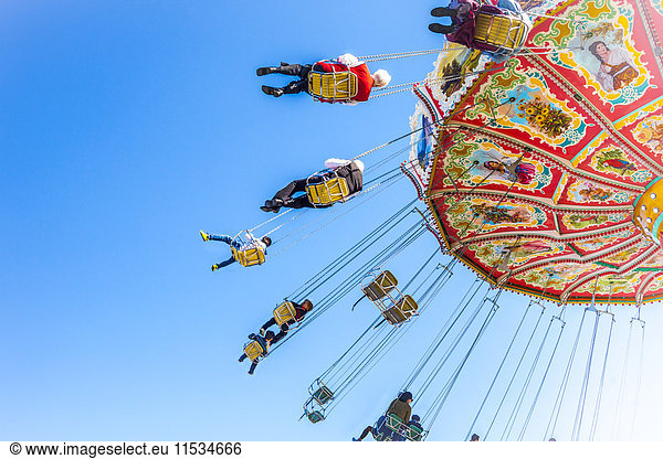 Germany  Munich  people enjoying ride on carousel during Oktoberfest