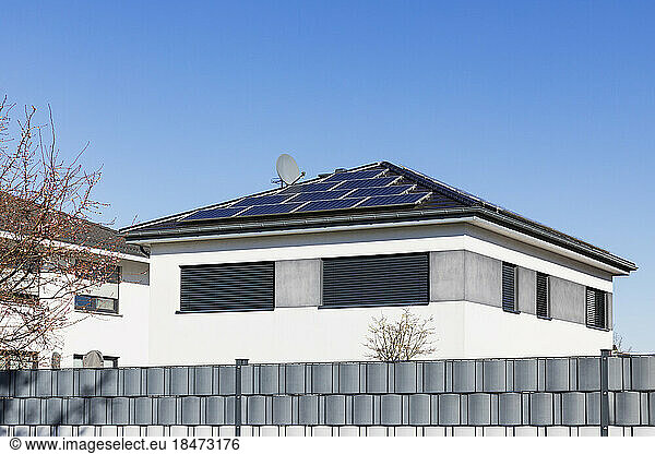 Germany  North Rhine Westphalia  Cologne  Clear sky over modern houses with solar roof panels