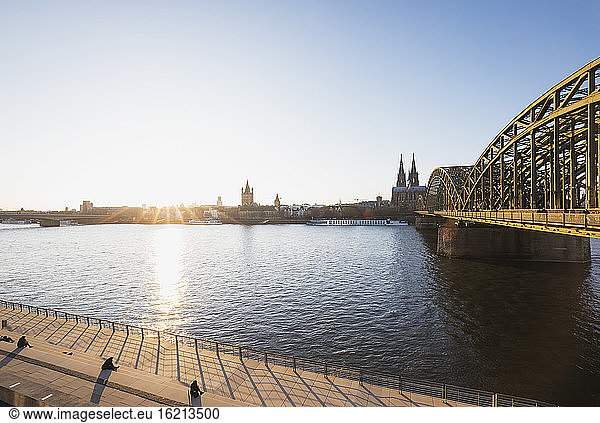 Germany  North Rhine-Westphalia  Cologne  Sun setting over Rhine with Hohenzollern Bridge and Cologne Cathedral in background