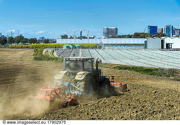 Germany  North Rhine-Westphalia  Dusseldorf  Tractor plowing field