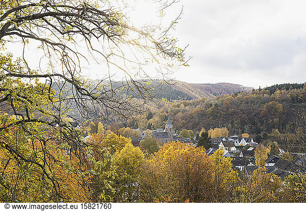 Germany  North Rhine-Westphalia  Einruhr  Village surrounded by forested hills in autumn
