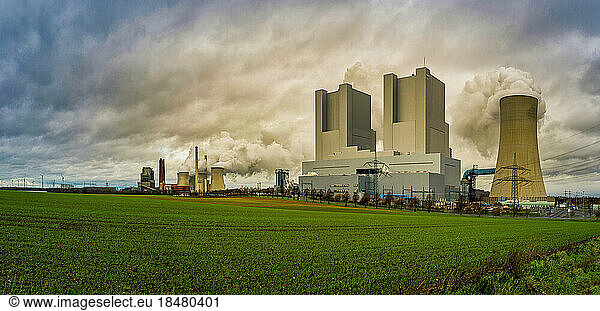 Germany  North Rhine Westphalia  Grevenbroich  Panoramic view of agricultural field in front of lignite-fired power station