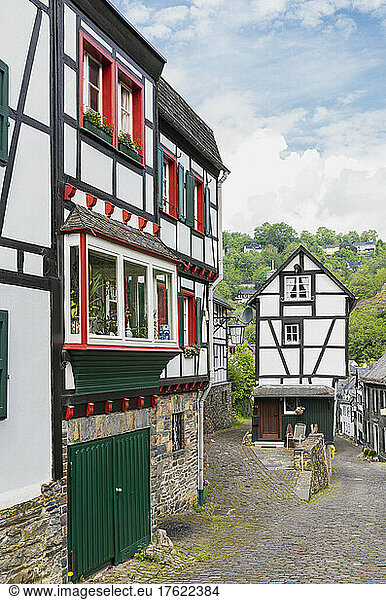 Germany  North Rhine-Westphalia  Monschau  Half-timbered townhouses along street in medieval town