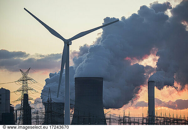 Germany  North Rhine Westphalia  Niederaussem  Wind turbines and lignite power station at sunset