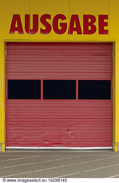 Germany  part of facade with red roller shutter of a wrapping counter