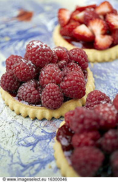 Germany  Raspberry cakes on table  close up