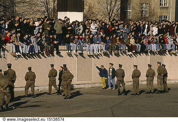 Germany  reunification  fall of the Berlin Wall  people sitting and standing on wall in front of the Brandenburg Gate  November  1989  GDR  FRG  German Democratic Republik  Federal Repuplic of Germany  wall  opening  border patrol of the GDR  historic  historical  November'89  November 89  1980s  20th century