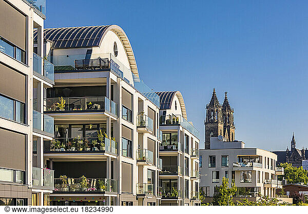 Germany  Saxony-Anhalt  Magdeburg  Modern apartments with bell towers of Magdeburg Cathedral in background