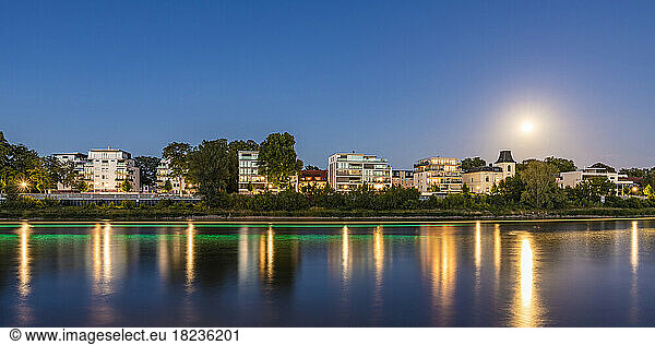 Germany  Saxony-Anhalt  Magdeburg  Panorama of riverside apartments of Werder district at dusk