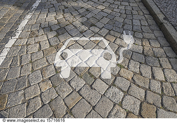 Germany  Saxony-Anhalt  Quedlinburg  Electric car charging station symbol on cobblestone