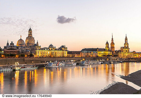Germany  Saxony  Dresden  Elbe river at sunset with moored tourboats and Dresden Academy of Fine Arts in background