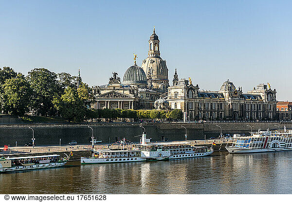 Germany  Saxony  Dresden  Elbe river with moored tourboats and Dresden Academy of Fine Arts in background