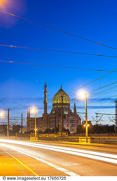 Germany  Saxony  Dresden  Vehicle light trails stretching along street at dusk with Yenidze factory in background