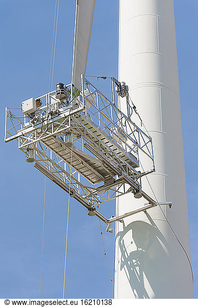 Germany  Saxony  Maintenance lift of wind turbine against sky