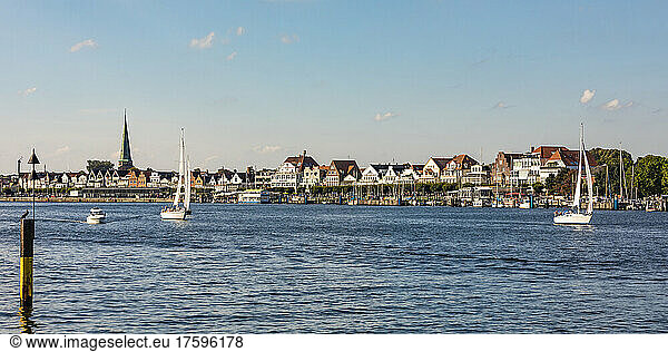 Germany  Schleswig-Holstein  Lubeck  Boats on river Trave with townhouses in background