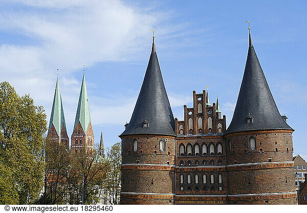 Germany  Schleswig-Holstein  Lubeck  Holstentor with spires of Marienkirche in background
