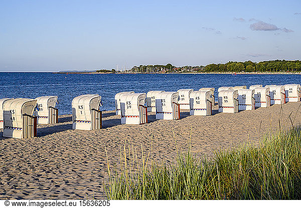 Germany  Schleswig-Holstein  Niendorf  Strandkorb beach-chairs on sandy coastal beach