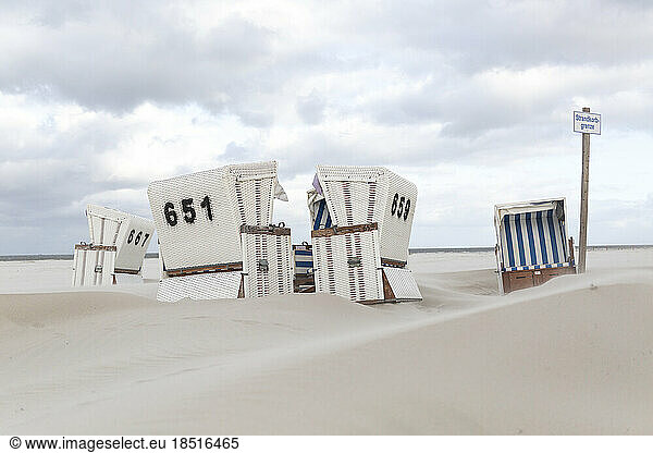 Germany  Schleswig-Holstein  St. Peter-Ording  Hooded beach chairs on sandy beach
