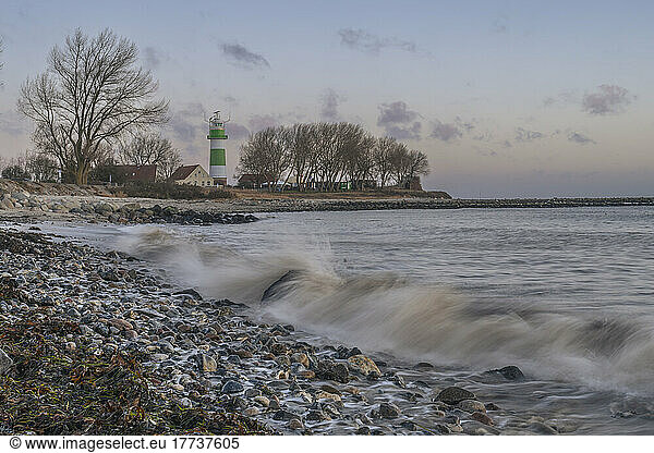 Germany  Schleswig-Holstein  Strande  Rocky coastline with lighthouse in background