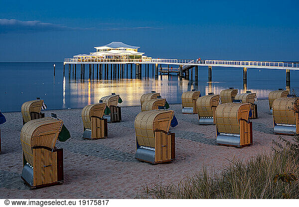 Germany  Schleswig-Holstein  Timmendorfer Strand  Hooded beach chairs with pier and Mikado tea house in background