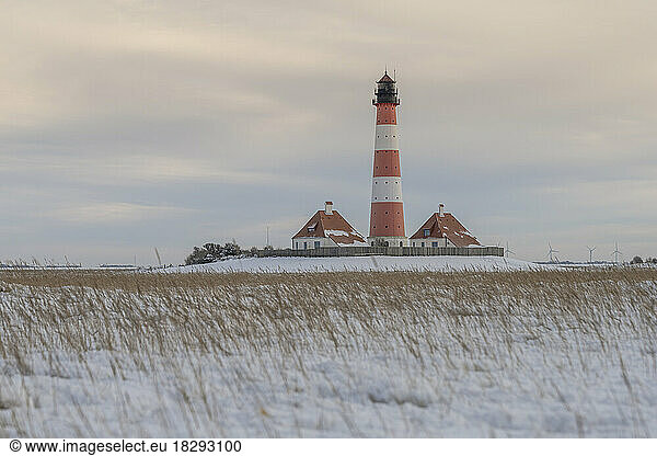 Germany  Schleswig-Holstein  Westerhever  Snow-covered field in front of Westerheversand Lighthouse