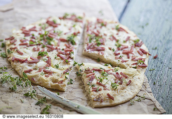 Germany  Tarte with onions and ham on table