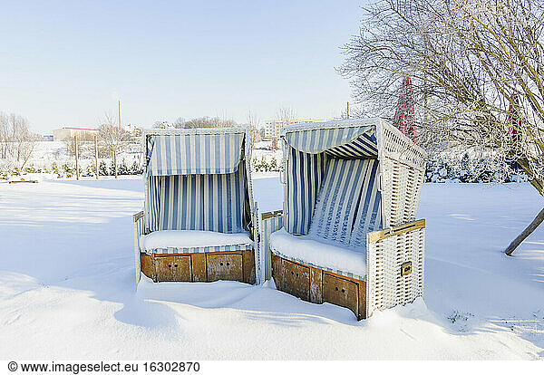 Germany  two snow covered hooded beach chairs