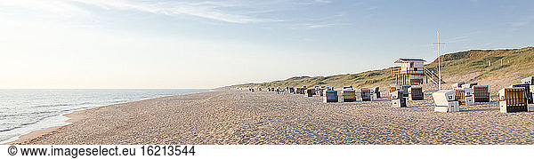Germany  View of empty beach with roofed wicker beach chairs on Sylt island