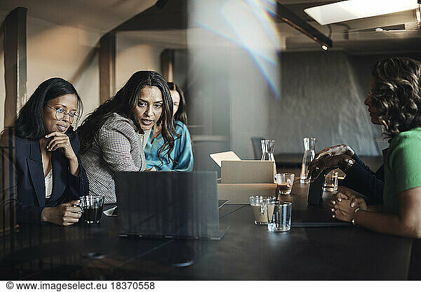 Geschäftsfrauen  die eine Besprechung am Laptop am Schreibtisch im Büro abhalten