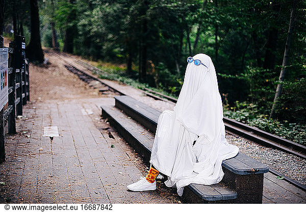 Ghost Waits Beside Train Tracks Wearing Sunglasses
