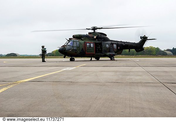 Gilze-Rijen Netherlands. Military Cougar helicopter taking of and departing from an airbase platform.