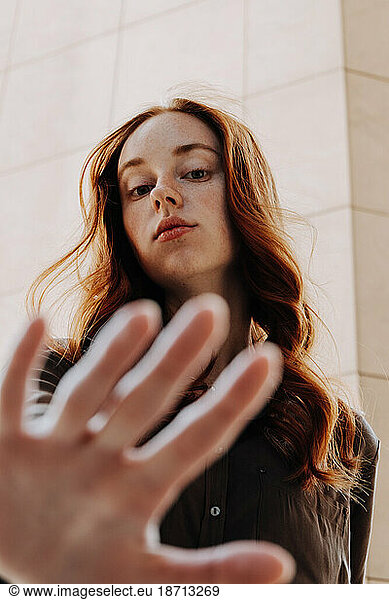 Ginger Girl with Freckles at Sunset near Old Architecture