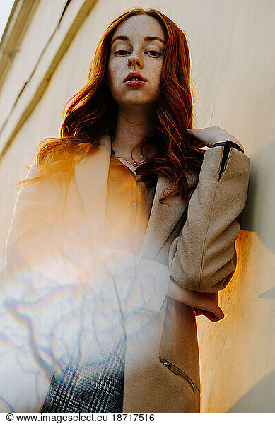 Ginger Girl with Freckles at Sunset near Old Architecture