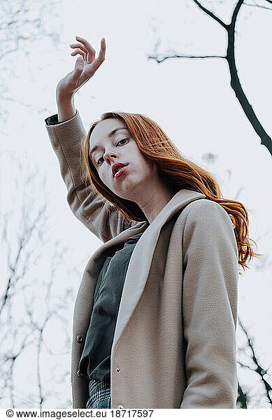 Ginger Girl with Freckles at Sunset near Old Architecture