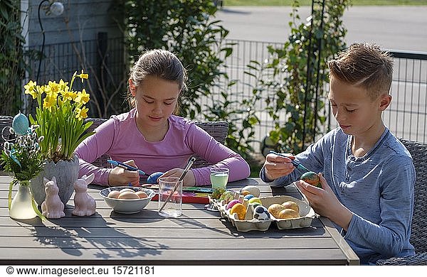 Girl and boy  children painting Easter eggs  Bavaria  Germany  Europe