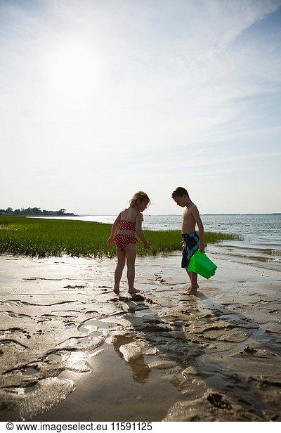 Girl and boy on beach at low tide