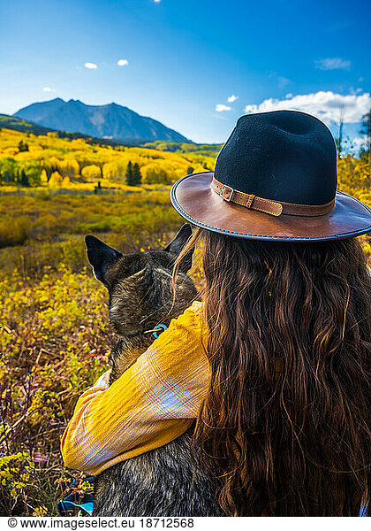 Girl and Dog Leaf Peeping the Fall Colors on Kebler Pass in Colorado