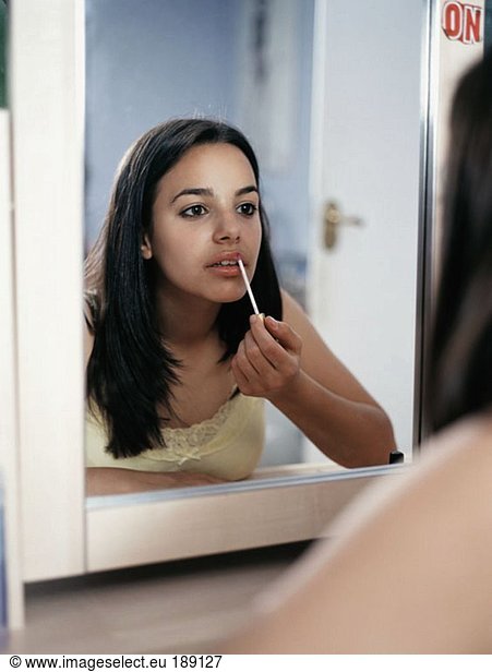 Girl applying lipgloss