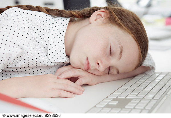 Girl asleep on computer keyboard