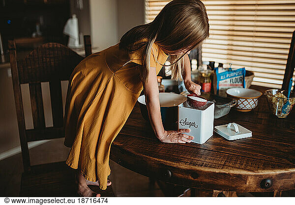 Girl at table preparing food