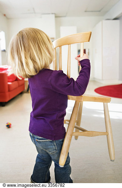 Girl carrying chair