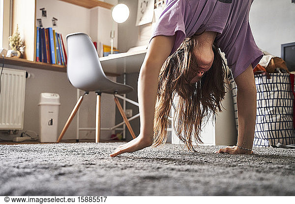 Girl doing handstand at home