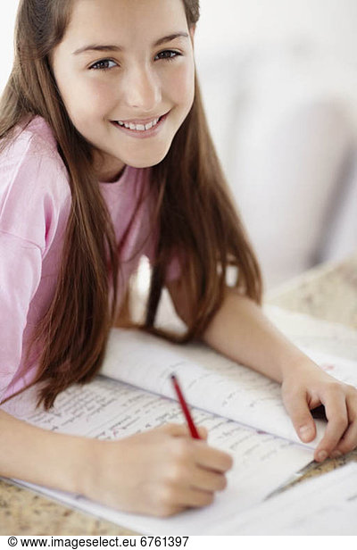 Girl (10-11) doing homework