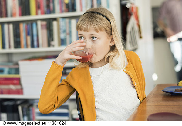 Girl drinking juice at home
